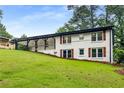 Charming home with a covered porch and well-manicured lawn, surrounded by mature trees at 3536 Redwine Ct, Atlanta, GA 30344
