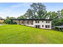 Charming home with a covered porch and well-manicured lawn, surrounded by mature trees at 3536 Redwine Ct, Atlanta, GA 30344
