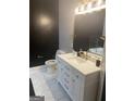 Bathroom featuring a white vanity, hexagon tile floors, and black accent wall at 870 Mayson Turner Nw Rd # 1102, Atlanta, GA 30314
