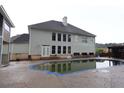 Back of house featuring a swimming pool and an outdoor area great for relaxation at 168 Harmony Grove Rd, Lilburn, GA 30047