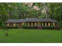Inviting brick home featuring a covered porch and windows illuminated with a warm, cozy light at dusk at 286 Hilton Way Way, Canton, GA 30114