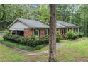 Brick home side view, showcasing lush landscaping and a winding walkway to the front entrance at 286 Hilton Way Way, Canton, GA 30114
