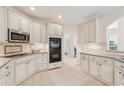 Kitchen with granite countertops, stainless appliances, and white cabinetry at 3743 Lake Edge Dr, Suwanee, GA 30024