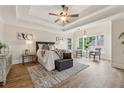 Main bedroom with tray ceiling, wood floors, and sitting area at 3743 Lake Edge Dr, Suwanee, GA 30024