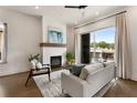 Cozy living room features a modern fireplace, contemporary furniture, and access to a balcony with a view at 2347 Hosea L Williams Ne Dr # 11, Atlanta, GA 30317