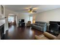 Spacious living room boasts hardwood floors, a ceiling fan, and an archway to the dining area at 4424 High Gate Nw Dr, Acworth, GA 30101