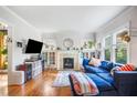 Bright living room with hardwood floors, fireplace, built-ins and a comfortable blue sofa at 451 S Columbia Dr, Decatur, GA 30030
