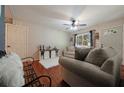 Cozy living room with hardwood floors, neutral furniture, ceiling fan, and lots of natural light at 57 Jonathan Rd, Riverdale, GA 30274