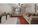 Bright living room with hardwood floors, neutral paint, comfortable sofas, and lots of natural light at 57 Jonathan Rd, Riverdale, GA 30274