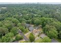 An aerial view showcases the property nestled amongst lush greenery, with the city skyline in the distance at 2123 Drew Valley Ne Rd, Brookhaven, GA 30319