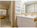 Cozy bathroom featuring a white vanity, cabinet, and patterned floors at 5365 Winding Ln, Suwanee, GA 30024