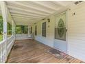 Inviting front porch with a white railing, a decorated front door, and a wooden floor at 5365 Winding Ln, Suwanee, GA 30024