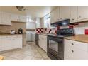 Functional kitchen with white cabinets, tiled floors, and modern appliances at 5365 Winding Ln, Suwanee, GA 30024
