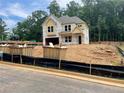 Two-story home exterior view showcases construction with a covered porch and a two-car garage at 731 Crest Line Trl, Powder Springs, GA 30127