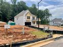 Two-story home exterior view showcases construction with a covered porch and a two-car garage at 731 Crest Line Trl, Powder Springs, GA 30127