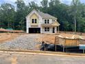 Two-story home exterior view showcases construction with a covered porch and a two-car garage at 731 Crest Line Trl, Powder Springs, GA 30127