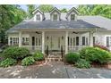 Inviting front porch with elegant columns and a beautifully landscaped garden at 2058 Sewanee Ct, Villa Rica, GA 30180