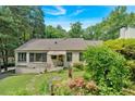 Inviting one-story home featuring a well-maintained yard and blooming flowerbeds at 251 Beverly Ne Rd, Atlanta, GA 30309