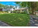 Lovely landscaped front yard and a long driveway leading to a detached garage at 251 Beverly Ne Rd, Atlanta, GA 30309