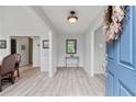 Inviting foyer with new floors, fresh gray paint, a decorative mirror, and a charming wreath on the blue front door at 4434 Austin Hills Dr, Suwanee, GA 30024