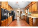 Traditional eat-in kitchen featuring wooden cabinetry, laminate countertops, and vintage details at 5760 Windermere Ct, Lithonia, GA 30038