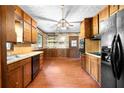 Traditional eat-in kitchen featuring wooden cabinetry, laminate countertops, and vintage details at 5760 Windermere Ct, Lithonia, GA 30038