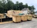 Image shows the beginning stages of the building of a home and debris receptacles at 727 Crest Line Trl, Powder Springs, GA 30127