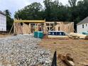 Image shows the beginning stages of the building of a home with lumber and other materials present at 727 Crest Line Trl, Powder Springs, GA 30127