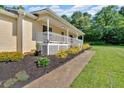 Landscaped front yard featuring mulch beds lining the home and a sidewalk to the entrance at 19 Quail Hollow Ct, Dallas, GA 30157