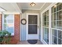 Inviting front door with a wreath, sidelight windows and a brick facade at 2611 Leeshire Ct, Tucker, GA 30084