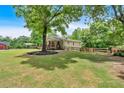 Beautiful home nestled among mature trees, showcasing a well-maintained lawn and welcoming exterior at 428 Hulseytown Rd, Dallas, GA 30157