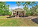 Inviting home with a well-manicured lawn, complemented by lush trees and decorative front porch at 428 Hulseytown Rd, Dallas, GA 30157