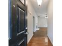 A home's entryway reveals hardwood flooring and transitions to a living space with natural light at 10247 Deep Creek Pl, Union City, GA 30291