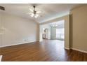 The open-concept living room showcases hardwood floors, a ceiling fan, and lots of natural light at 10247 Deep Creek Pl, Union City, GA 30291