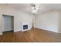 Spacious living room featuring a fireplace, ceiling fan, and hardwood floors at 10247 Deep Creek Pl, Union City, GA 30291