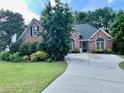Inviting brick home with a well-manicured lawn and a spacious driveway at 1902 Commons View Cir, Snellville, GA 30078