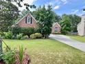 Well-maintained brick home with a beautiful front lawn and mature trees at 1902 Commons View Cir, Snellville, GA 30078