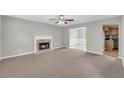 Spacious living room with a cozy fireplace and an open layout that flows into the dining area and kitchen at 4092 Arabian Way, Snellville, GA 30039
