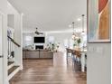 Open concept living space with hardwood floors, modern kitchen, and a cozy fireplace at 90 Citrine Way, Acworth, GA 30101