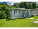 Cozy single-story house featuring a well-manicured lawn and inviting front porch at 511 Reid St, Villa Rica, GA 30180