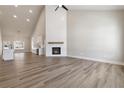 Bright open space features wood floors, a fireplace, tall ceilings and neutral walls at 2080 Cactus Ln, Cumming, GA 30040