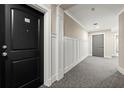Hallway view showcasing neutral paint and carpet with panel molding accenting the wall at 2277 Peachtree Ne Rd # 302, Atlanta, GA 30309