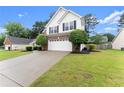 Lovely two-story home with a manicured lawn, a two-car garage, and a long driveway, ideal for curb appeal at 1980 Heatherton Rd, Dacula, GA 30019