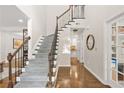 Bright entryway featuring hardwood floors, a staircase with iron railings, and natural light at 11260 Havenwood Dr, Johns Creek, GA 30097