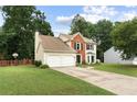 Beautiful two-story home with a well-maintained lawn and two-car garage, surrounded by mature trees at 2904 Masonwood Nw Dr, Kennesaw, GA 30152
