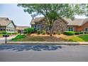 Charming stone and brick home with manicured front lawn and landscaping at 4347 Lanier Ridge Walk # 1501, Cumming, GA 30041