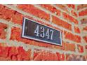 Close up of the house number '4347' on a brick wall at 4347 Lanier Ridge Walk # 1501, Cumming, GA 30041
