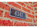 Close-up of the house number '4347' on a weathered brick wall at 4347 Lanier Ridge Walk # 1501, Cumming, GA 30041
