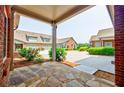 Stone patio area featuring a view of the property and garages at 4347 Lanier Ridge Walk # 1501, Cumming, GA 30041
