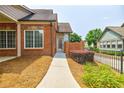 Brick townhome with a front walkway and lush, trimmed landscaping at 4347 Lanier Ridge Walk # 1501, Cumming, GA 30041
